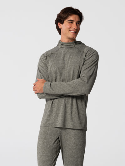 Man wearing Hot Chillys Clima-Tek hoodie and bottom base layer set in dark olive, front view