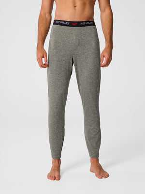 Man wearing Hot Chillys Clima-Tek bottom base layer in dark olive
