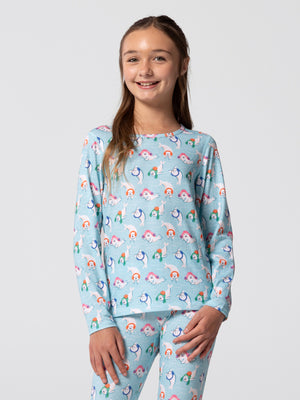 Front view of youth wearing Hot Chillys Originals Winter Seals print crewneck top and matching bottoms in light blue