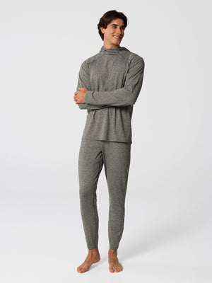Man wearing Hot Chillys Clima-Tek hoodie and bottom base layer set in dark olive, front view
