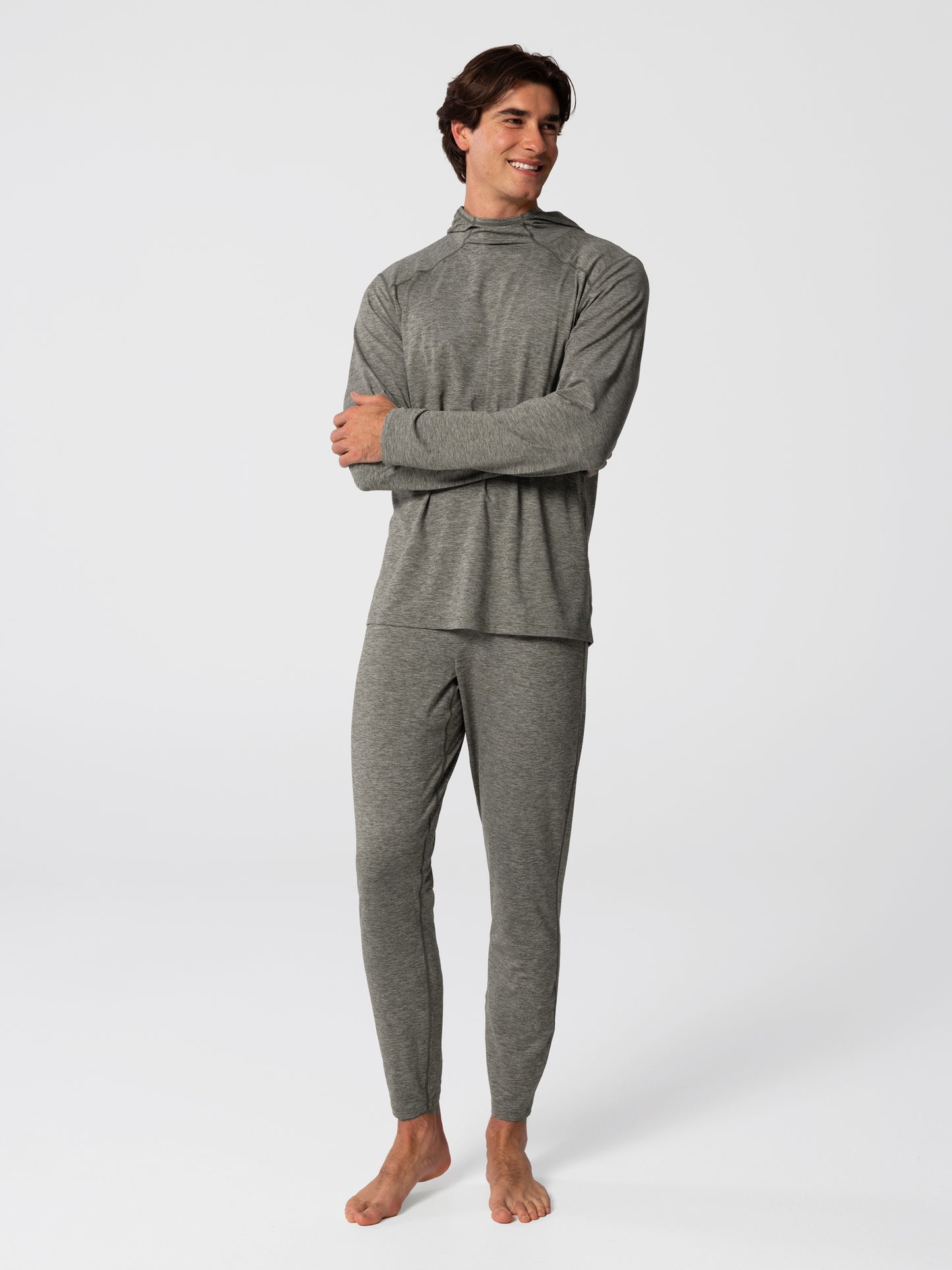 Man wearing Hot Chillys Clima-Tek hoodie and bottom base layer set in dark olive, full body view