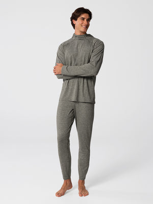 Man wearing Hot Chillys Clima-Tek hoodie and bottom base layer set in dark olive, full body view