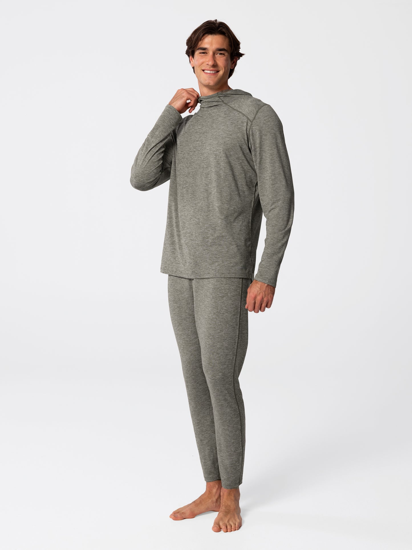 Man wearing Hot Chillys Clima-Tek hoodie and bottom base layer set in dark olive, full body view