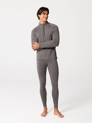 Full-body view of man wearing Hot Chillys Micro-Elite Chamois granite zip-neck top and granite thermal tights