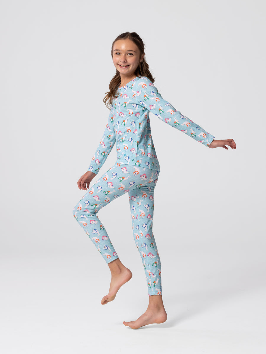 Full-body view of youth wearing Hot Chillys Originals Winter Seals print crewneck top and matching leggings in light blue