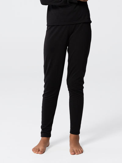 Kid wearing Hot Chillys youth Pepper Skins base layer bottom in black