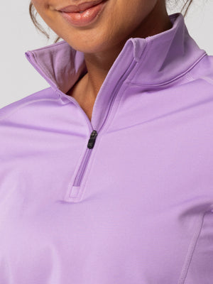 Close-up of the quarter-zip collar and zipper pull on Hot Chillys Micro-Elite Chamois Zip-T in light lavender, worn by a model