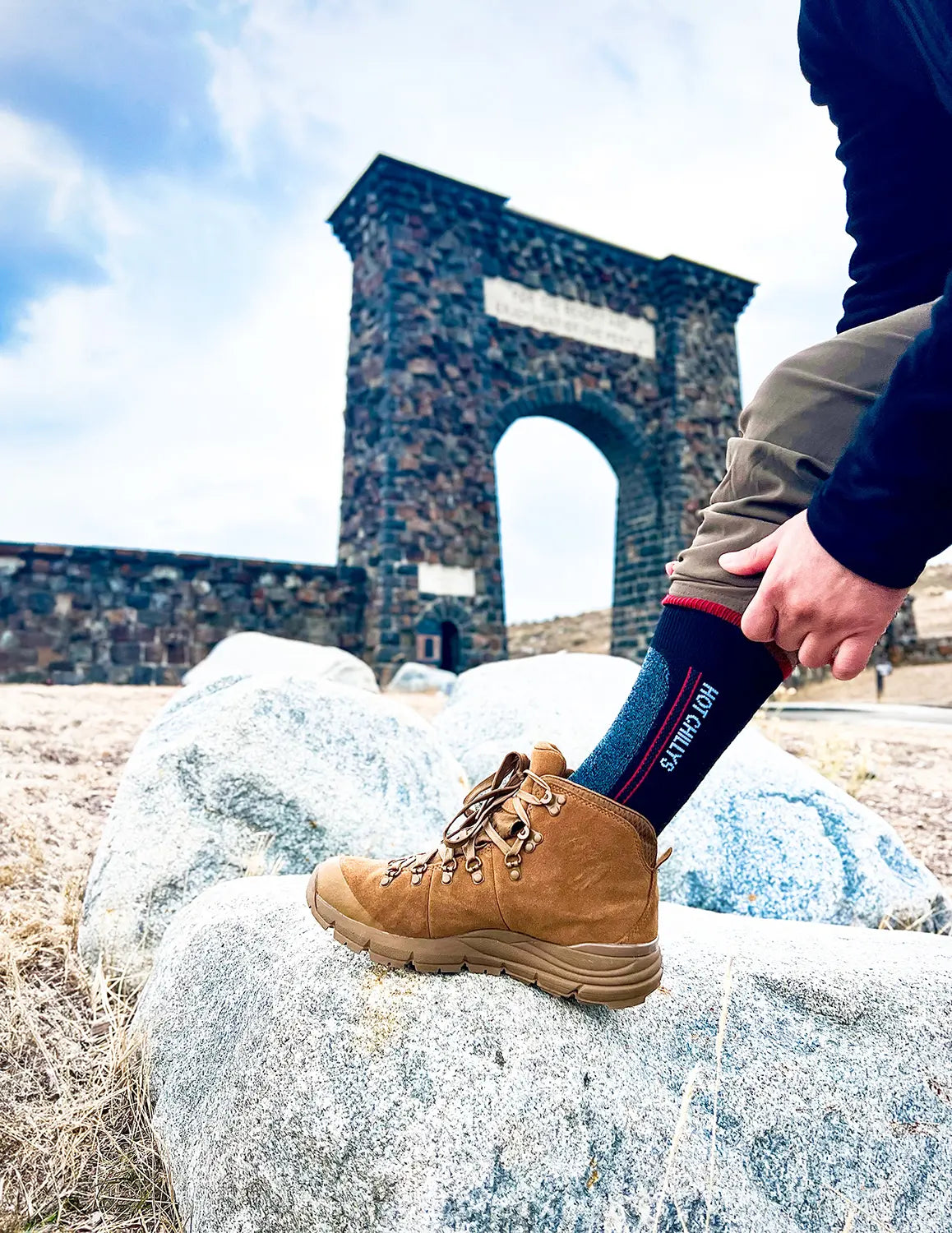 Hiker wearing Hot Chillys Elite Heat socks at the north entrance to Yellowstone National Park