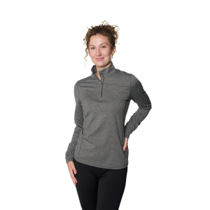 Woman wearing a gray long-sleeve shirt with a quarter zip on a white background