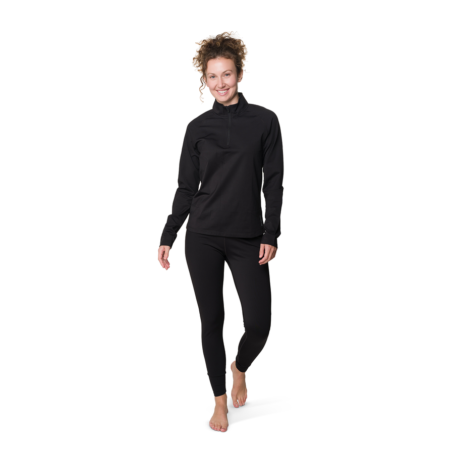 A woman modeling a black long-sleeve quarter-zip pullover and matching black leggings against a plain white background.