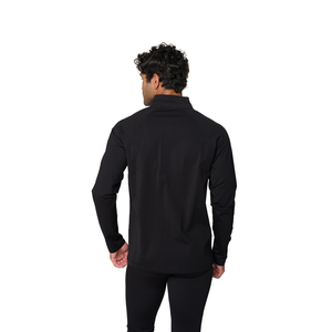 A man viewed from the back wearing a black long-sleeve mock neck shirt and black pants against a solid white background.