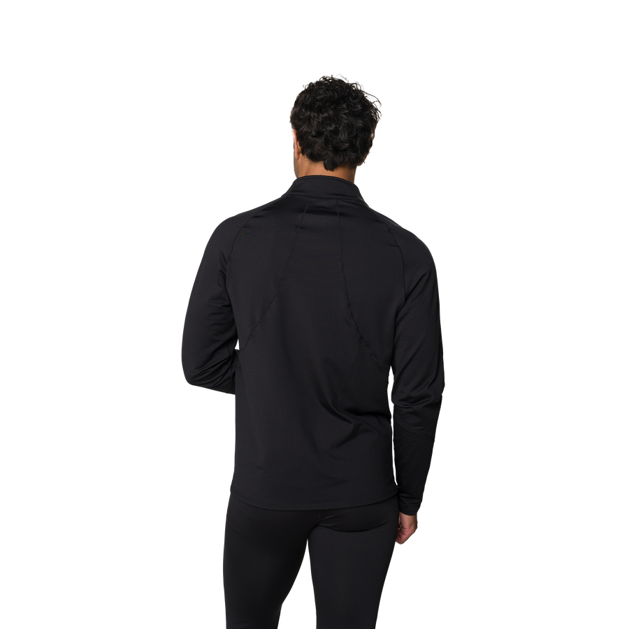 Person wearing a black long-sleeve shirt and pants on a white background
