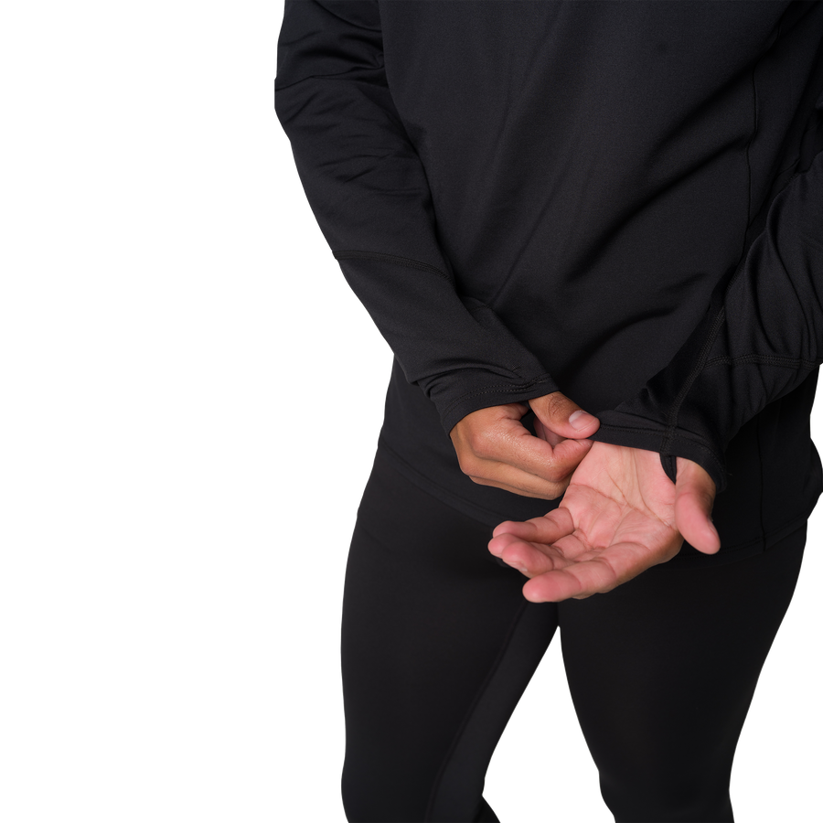 Person wearing a black long-sleeve shirt and pants on a white background