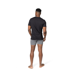 Back view of man wearing Hot Chillys clima-tek moisture wicking tee in black crewneck style