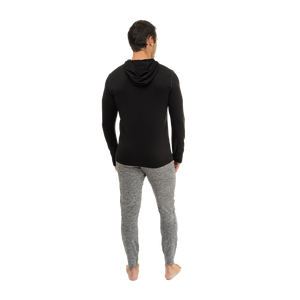 Back view of a man wearing Hot Chillys men's winter thermal hoodie in black with gray pants
