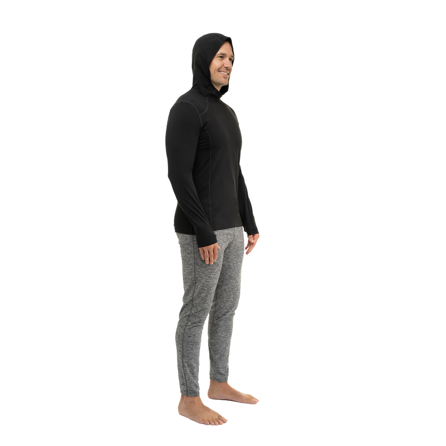 Hot Chillys men's winter thermal hoodie in black worn by smiling man in profile view