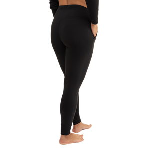 Hot Chillys women's black thermal joggers shown from the side with a high waistband and fitted design