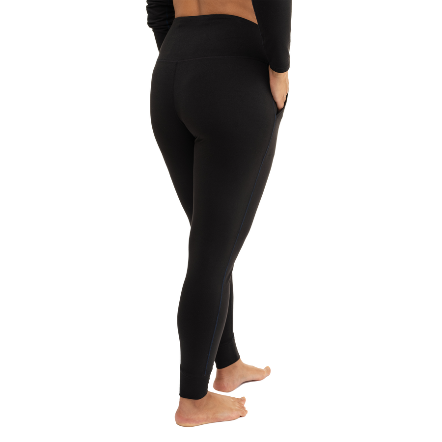 Hot Chillys women's black thermal joggers shown from the side with a high waistband and fitted design