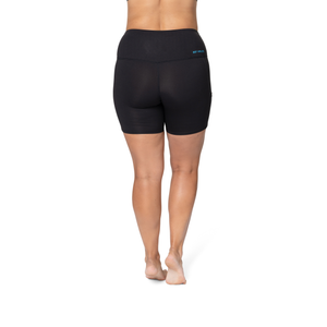 Hot Chillys women's winter athletic shorts in black shown from the back on a standing model